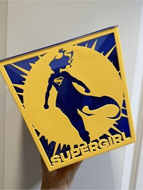 Yellow and Blue Supergirl Decorative Wall Panel - Heroic Silhouette Accent